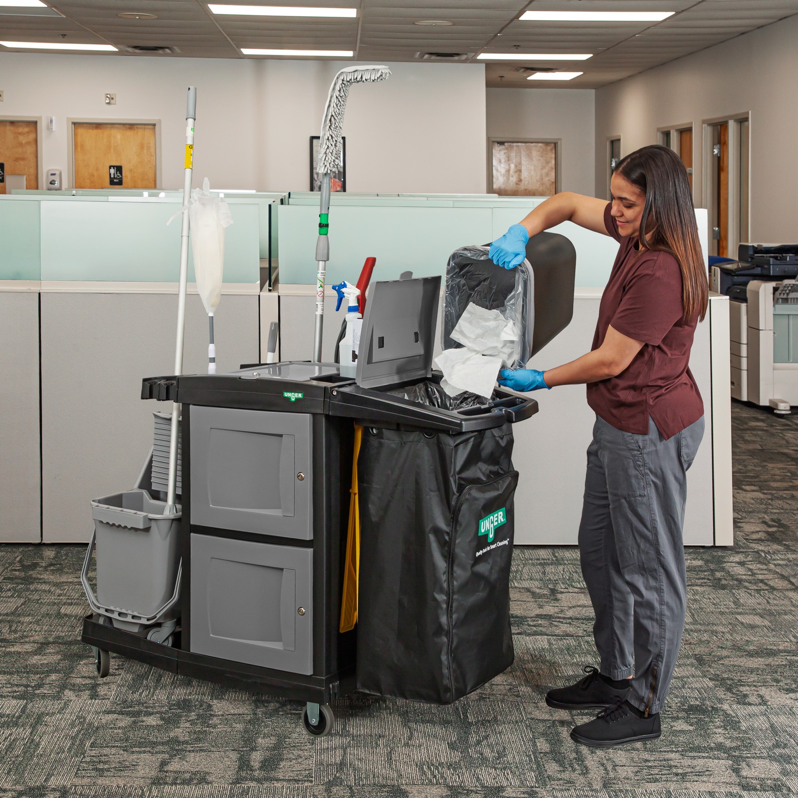 Cleaner changing the liner on a CleanRx cart in an office
